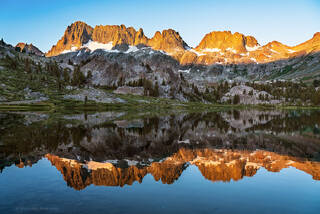 The Minarets reflect in Ediza lake as a perfect backcountry view in the Ansel Adams Wilderness and Mammoth Lakes Sierra.