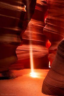 A beam of light cuts through the slot canyon of sandstone at Antelope Canyon in Page, Arizona.
