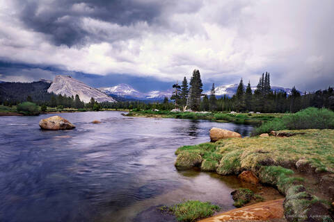 The Tuolumne River winds around Tuolumne Meadows and Lembert Dome in Yosemite National Park at sunset.