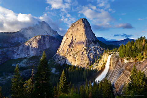 Springtime in Yosemite boasts a rushing water and glowing granite; Nevada fall, Liberty Cap, and Mt. Broderick bask in stormy light