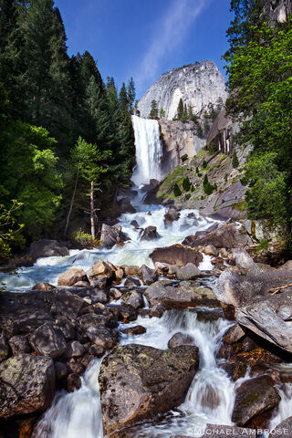 In the summer the Merced river water rushes over a cliff creating Vernal Fall in Yosemite National Park.