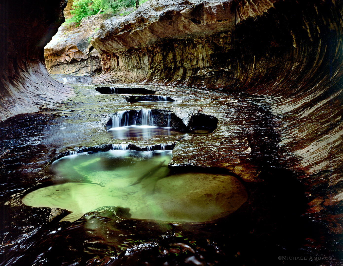 The subway pools are emerald pools of the Left Fork of North Creek in a tunnel-like slot canyon that doubles as a park trail for canyoneering in Zion.