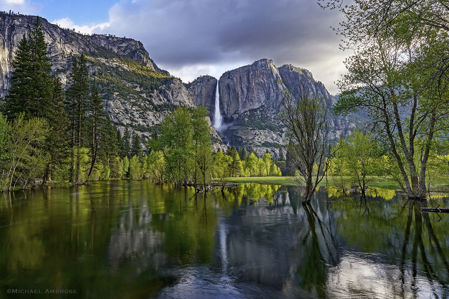 Reflections of Yosemite Falls crashing into the Merced River in Yosemite National Park in the Spring.