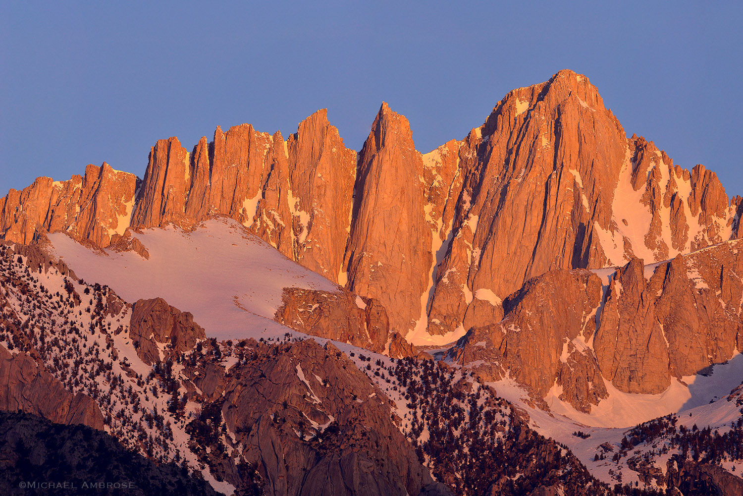 Mount Whitney Crest sunset alpenglow light and dusting of snow.